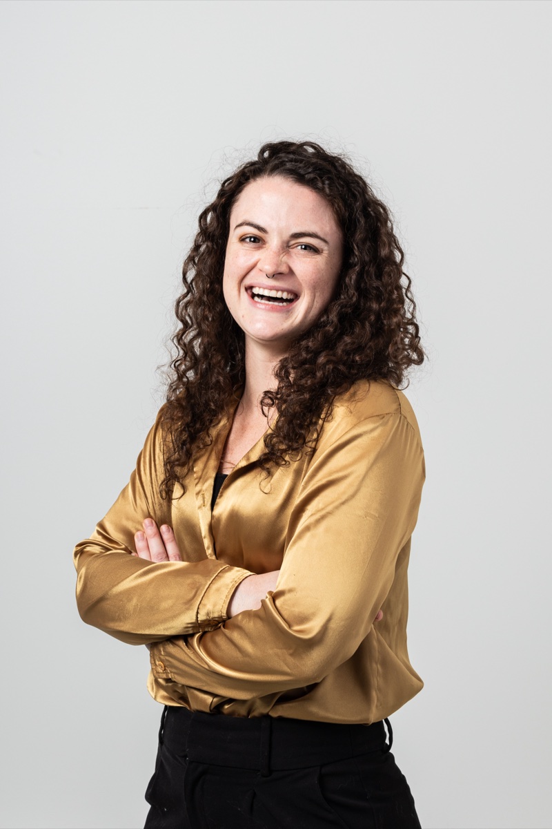 Shayna Stevermer laughing in a gold satin shirt